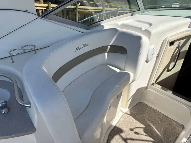 Slide: The Image of A sleek seating area on a 2006 Sea Ray Sundancer 320 boat, featuring white upholstery. - 8