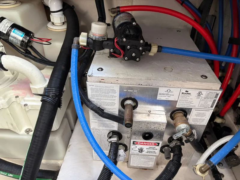 Slide: The Image of A technical area with hoses and valves, likely part of a boat's water system. - 22
