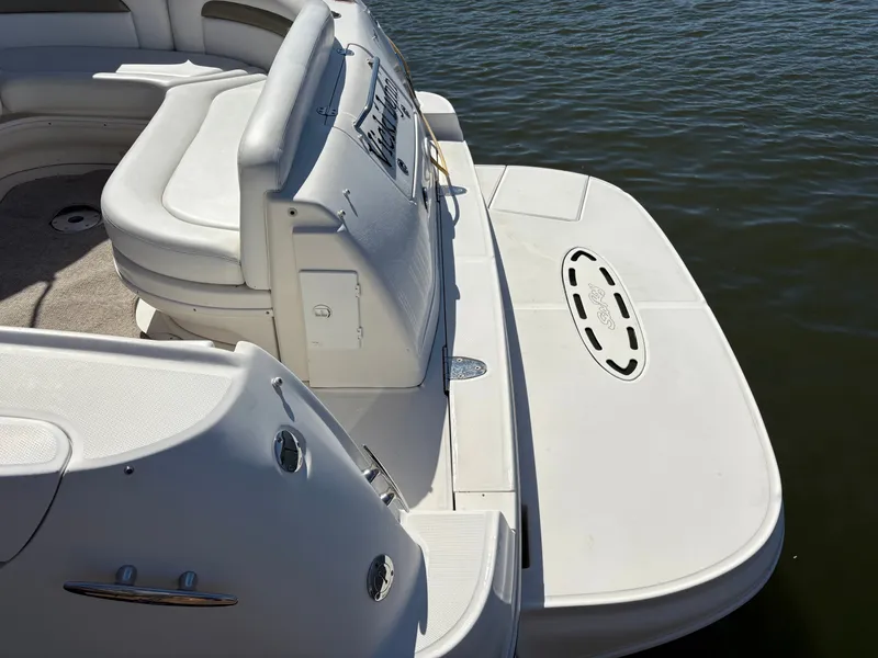 Slide: The Image of The image shows the stern of a 2006 Sea Ray Sundancer 320 with a spacious swim platform. - 4