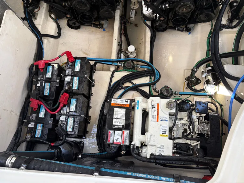 Slide: The Image of The engine compartment of a 2006 Sea Ray Sundancer 320 shows batteries and wiring. - 20