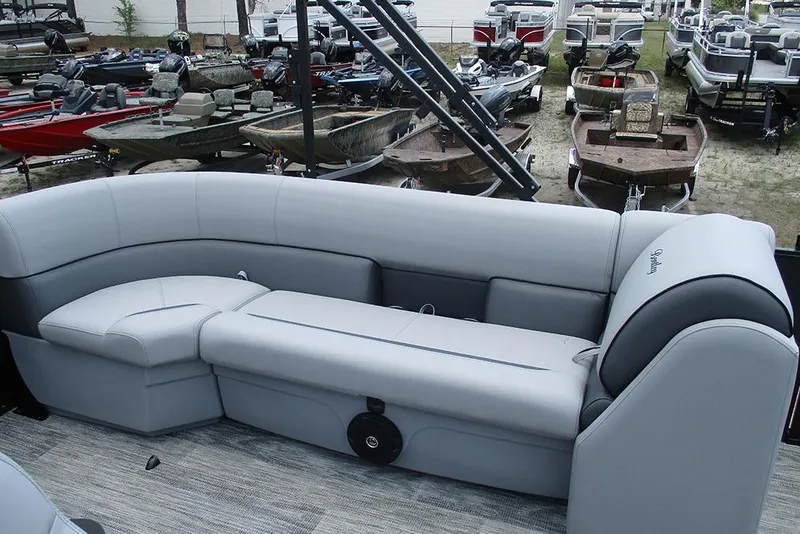 Slide: The Image of Luxurious seating on a 2026 Bentley Pontoons Bolt 203, surrounded by various boats. - 17