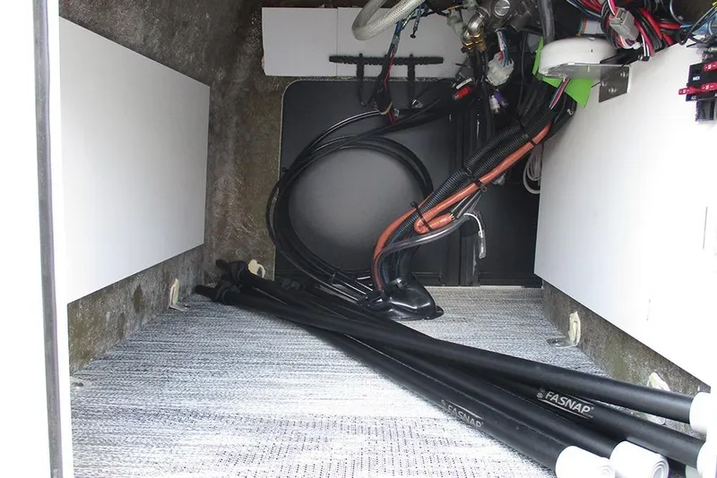Slide: The Image of Interior view of 2026 Bentley Pontoons Bolt 203, showcasing wiring and storage space. - 28