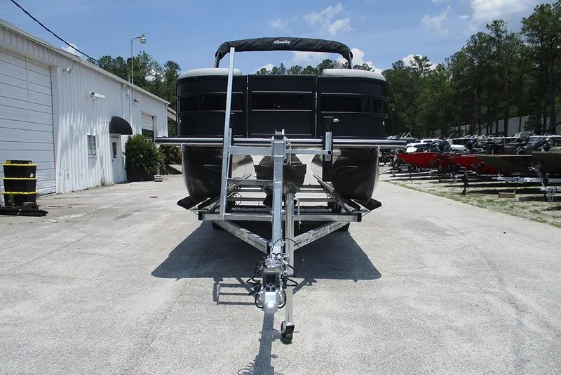 Slide: The Image of 2026 Bentley Pontoons Bolt 203 on trailer, parked outdoors near a white building. - 4
