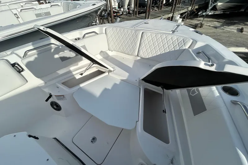 Slide: The Image of 2026 Sea Fox 268 Commander boat interior with open storage compartments and cushioned seating. - 14