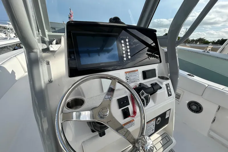 Slide: The Image of 2026 Sea Fox 268 Commander boat dashboard with steering wheel and control panel. - 6