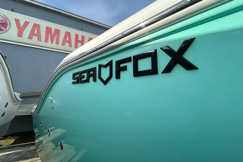 Slide: The Image of 2026 Sea Fox 268 Commander boat with Yamaha signage in the background. - 1