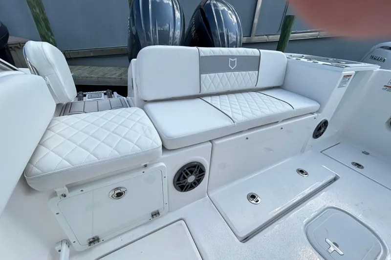 Slide: The Image of 2026 Sea Fox 268 Commander boat interior with white quilted seating and storage compartments. - 21
