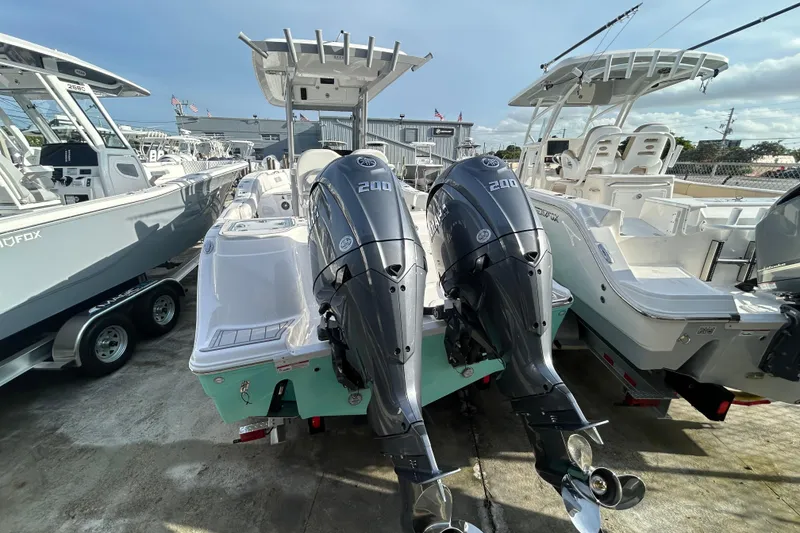 Slide: The Image of 2026 Sea Fox 268 Commander boat with dual 200 horsepower engines, docked outdoors. - 16