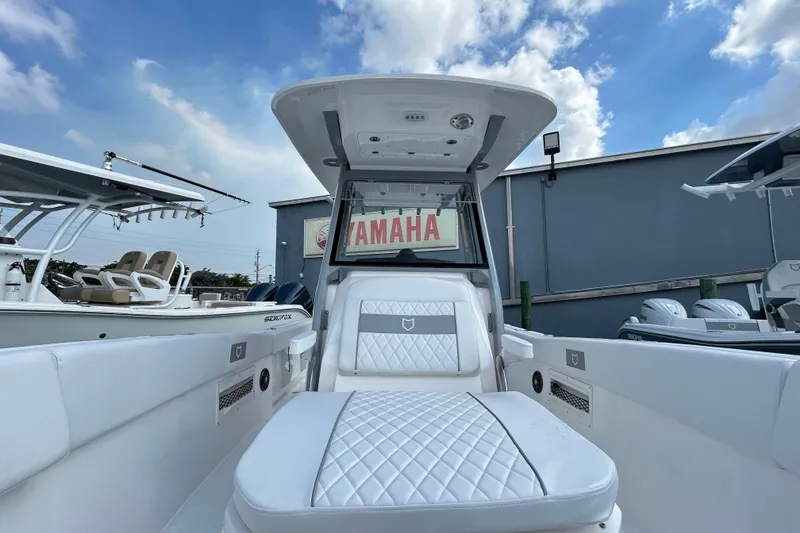 Slide: The Image of 2026 Sea Fox 268 Commander boat interior with luxurious seating under a clear blue sky. - 23