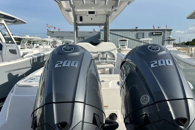 Slide: The Image of 2026 Sea Fox 268 Commander with dual 200 horsepower engines at a marina. - 15