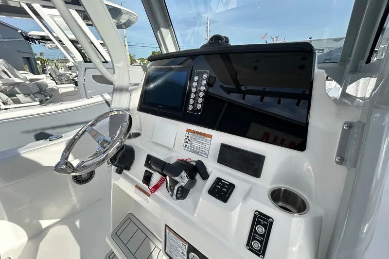 Slide: The Image of 2026 Sea Fox 268 Commander boat dashboard with steering wheel and control panel. - 7