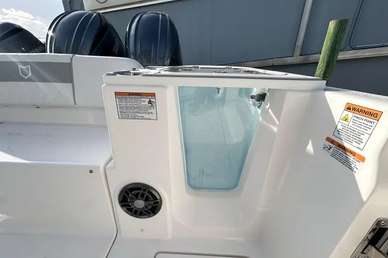 Slide: The Image of 2026 Sea Fox 268 Commander boat interior with livewell and warning labels. - 12
