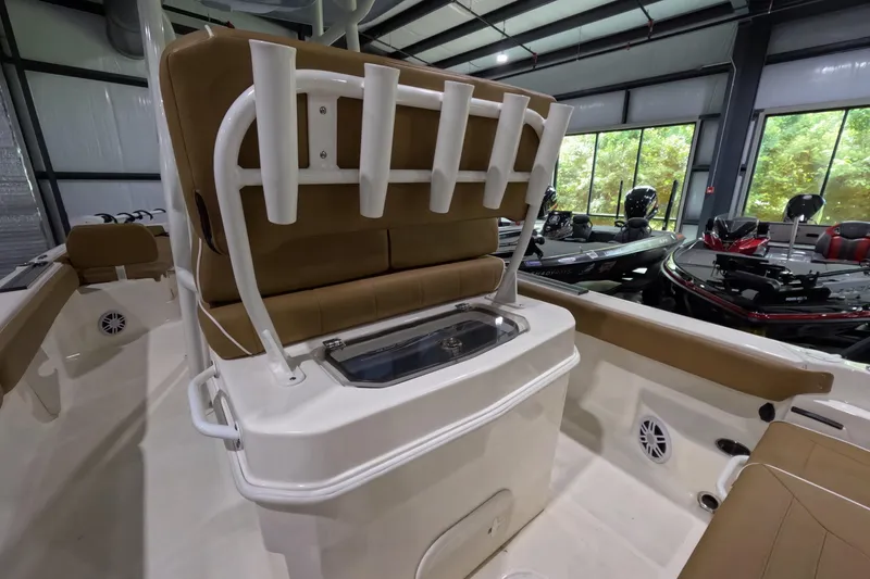 Slide: The Image of 2024 Skeeter SX2550 Family boat interior with rod holders and seating in a showroom. - 10
