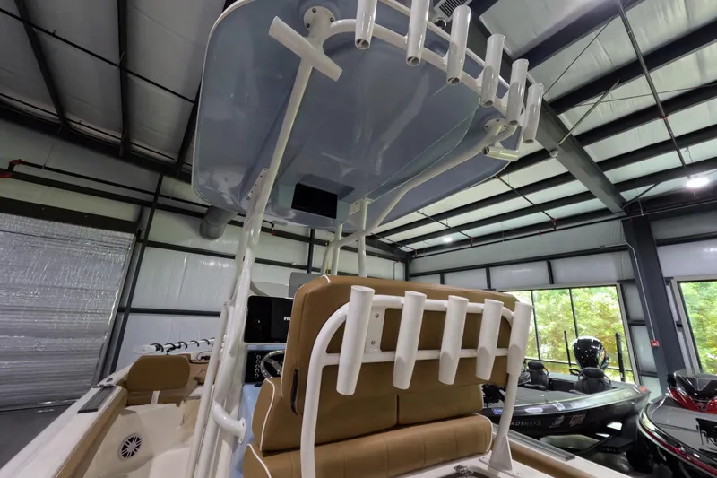 Slide: The Image of 2024 Skeeter SX2550 Family boat interior with rod holders and seating in a showroom. - 11