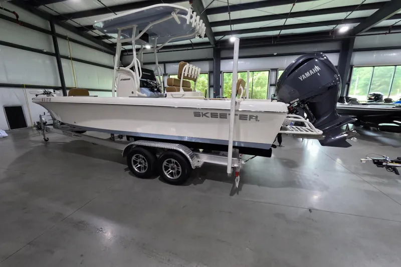 Slide: The Image of 2024 Skeeter SX2550 Family boat with Yamaha engine in a showroom. - 2