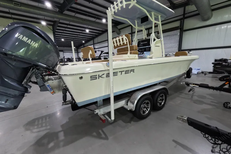 Slide: The Image of 2024 Skeeter SX2550 Family boat with Yamaha engine in a showroom setting. - 5