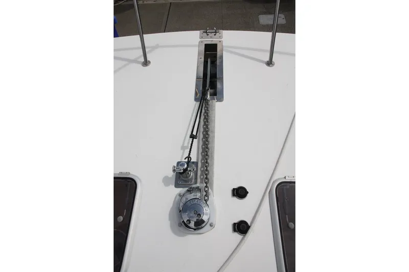 Slide: The Image of Anchor chain mechanism on 2004 TLD Custom Power Cat boat deck. - 7