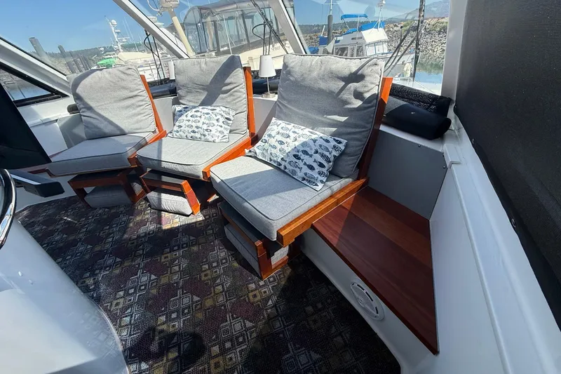Slide: The Image of Interior of 2004 TLD Custom Power Cat with cushioned seating and patterned carpet. - 18