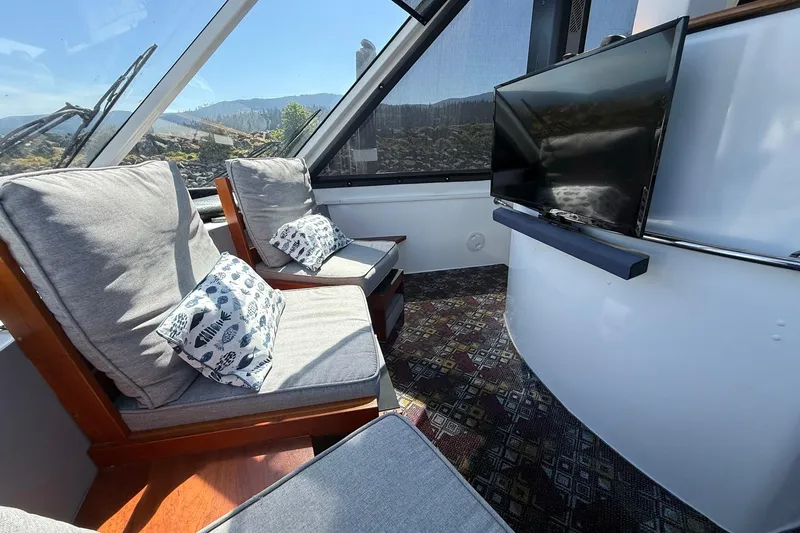 Slide: The Image of Luxurious 2004 TLD Custom Power Cat interior with plush seating and mounted TV. - 19