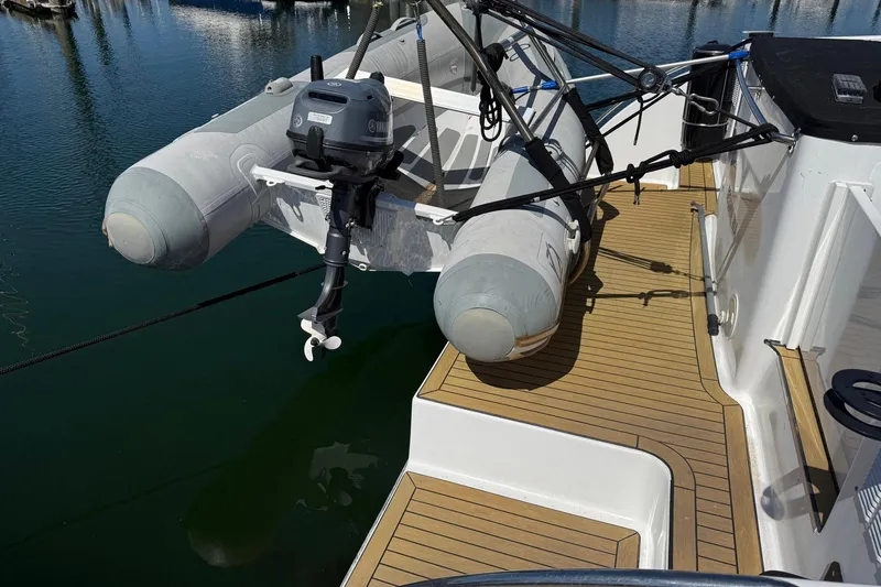 Slide: The Image of Inflatable boat with motor on 2004 TLD Custom Power Cat deck, docked at marina. - 3