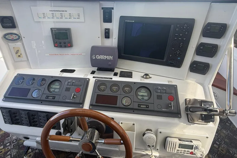 Slide: The Image of Control panel of a 2004 TLD Custom Power Cat with navigation instruments and steering wheel. - 14