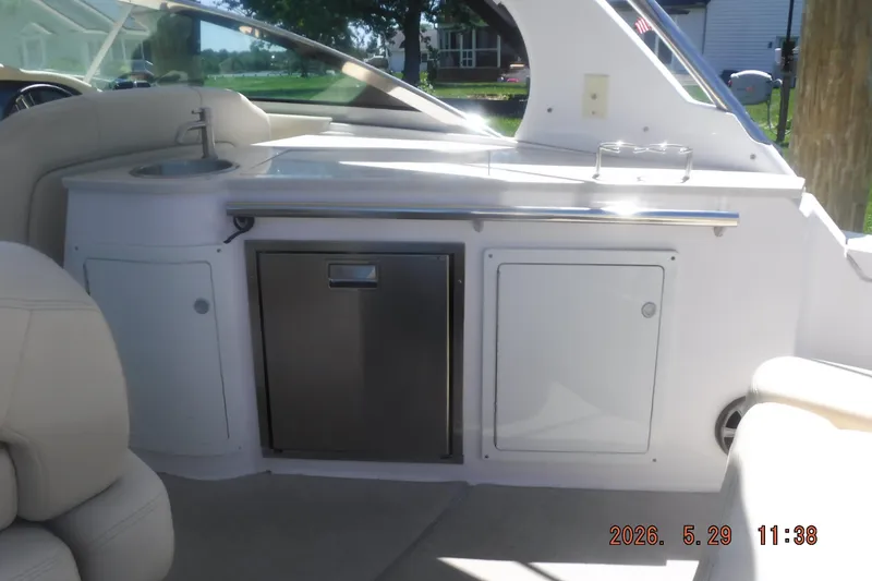 Slide: The Image of Interior of 2020 Regal 33 XO boat featuring a kitchenette with sink and storage. - 18
