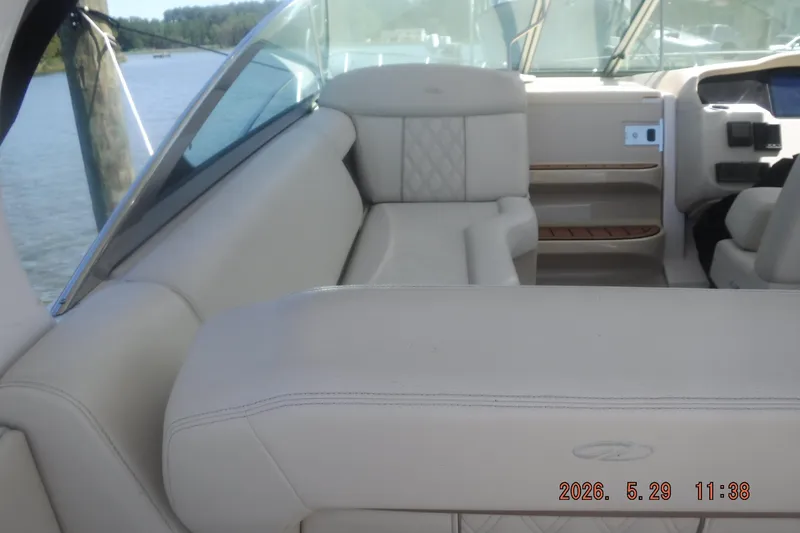 Slide: The Image of Interior of 2020 Regal 33 XO boat with beige seating and dashboard view. - 19