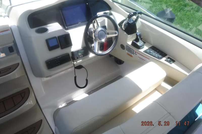 Slide: The Image of 2020 Regal 33 XO boat cockpit with steering wheel and control panel. - 25