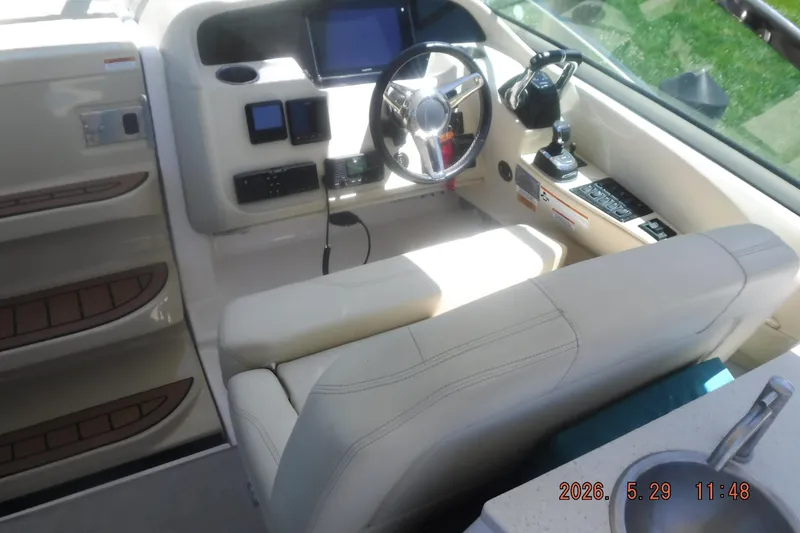 Slide: The Image of Cockpit of 2020 Regal 33 XO boat with steering wheel and control panel. - 26