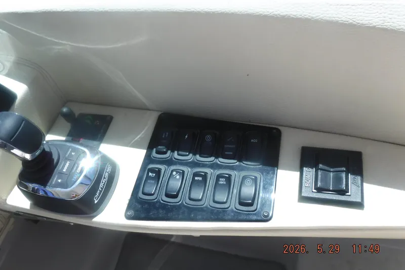 Slide: The Image of Control panel of a 2020 Regal 33 XO boat with joystick and switches. - 27