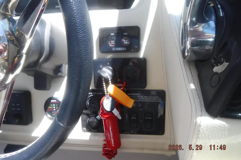 Slide: The Image of 2020 Regal 33 XO boat dashboard with steering wheel and control panel. - 29
