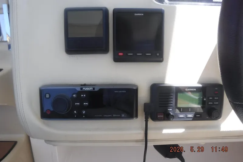 Slide: The Image of Control panel of a 2020 Regal 33 XO boat with Garmin and Fusion devices. - 30