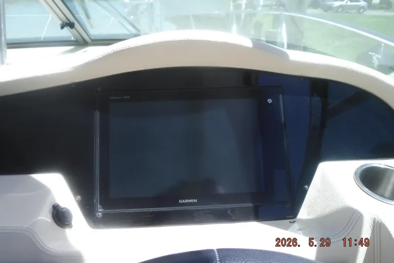 Slide: The Image of Dashboard of a 2020 Regal 33 XO boat featuring a Garmin GPS display. - 31