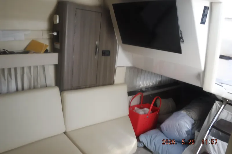 Slide: The Image of Interior of 2020 Regal 33 XO boat with sofa, TV, and storage area. - 36