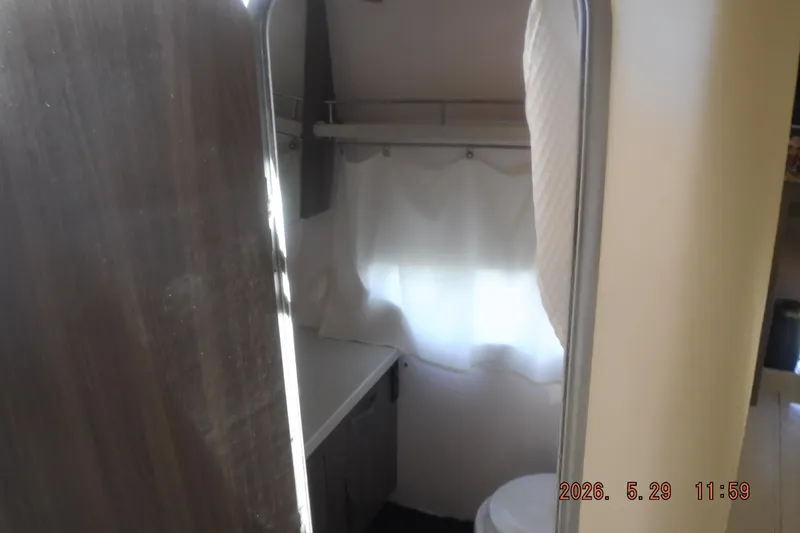 Slide: The Image of Interior of 2020 Regal 33 XO boat bathroom with curtain and countertop. - 40