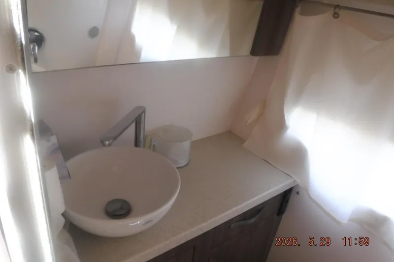 Slide: The Image of Modern bathroom sink area in a 2020 Regal 33 XO boat. - 42