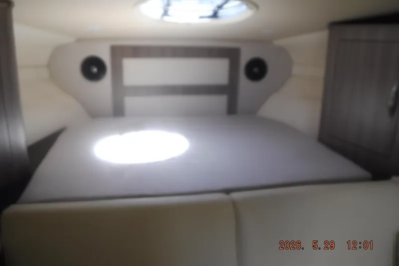 Slide: The Image of 2020 Regal 33 XO cabin interior with bed and overhead skylight. - 43
