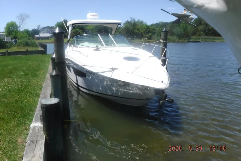 Slide: The Image of 2020 Regal 33 XO boat docked on a sunny day by the water. - 47