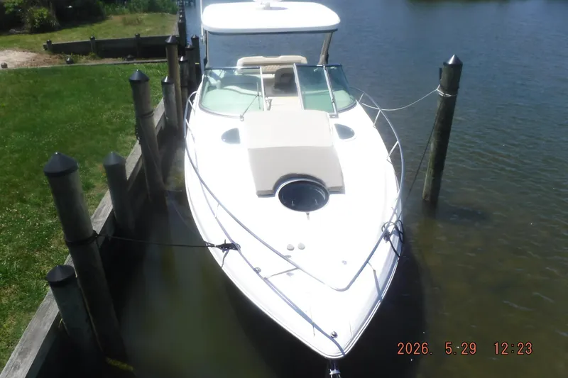 Slide: The Image of 2020 Regal 33 XO boat docked in a serene waterfront setting. - 48