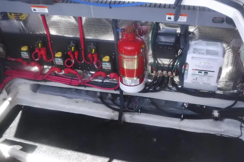 Slide: The Image of Engine compartment of a 2020 Regal 33 XO boat with wiring and fire extinguisher. - 49