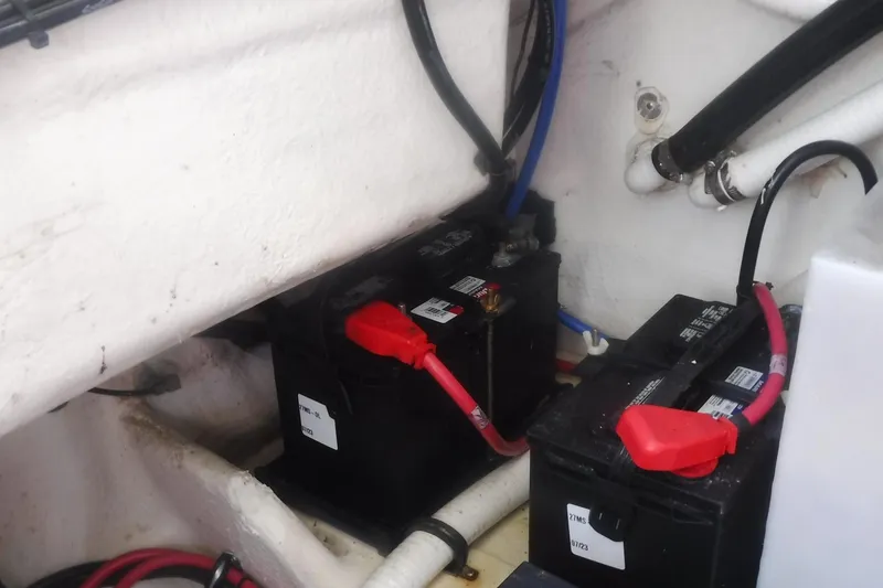 Slide: The Image of Battery compartment of a 2020 Regal 33 XO boat with connected cables. - 52