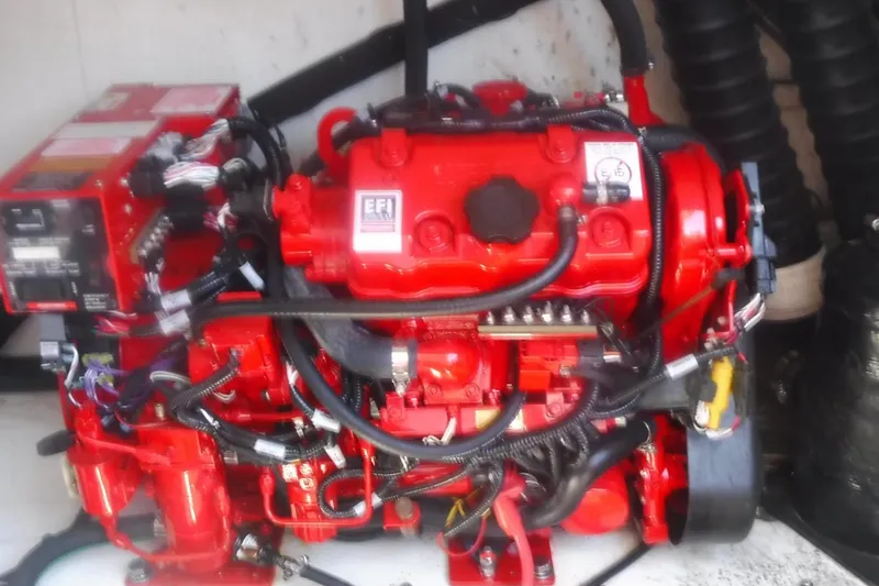 Slide: The Image of Red EFI engine in a 2020 Regal 33 XO boat, showcasing intricate wiring and components. - 53