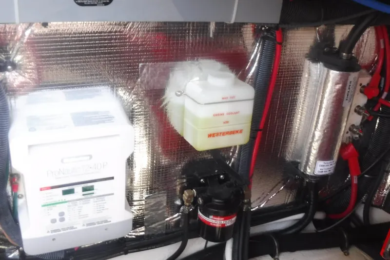 Slide: The Image of Engine compartment of 2020 Regal 33 XO with coolant and electrical components. - 54