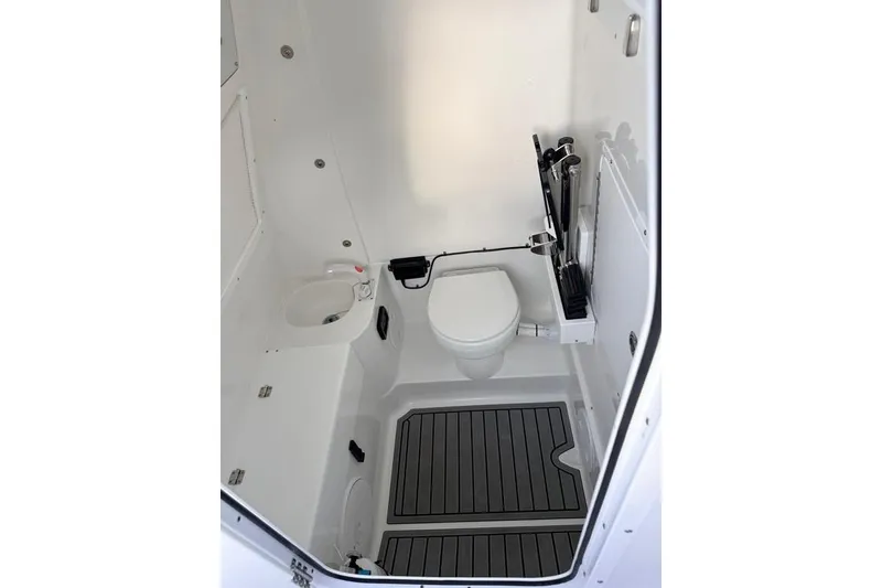 Slide: The Image of Interior of 2026 Sea Hunt Gamefish 30 Coffin Box boat, featuring a compact marine toilet. - 18