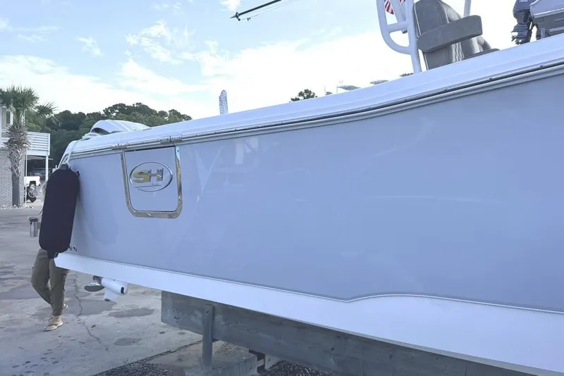 Slide: The Image of 2026 Sea Hunt Gamefish 30 Coffin Box boat on display at a marina. - 2