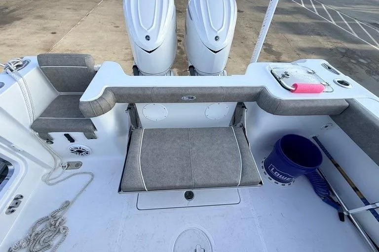 Slide: The Image of 2026 Sea Hunt Gamefish 30 Coffin Box boat interior with twin engines and seating area. - 23