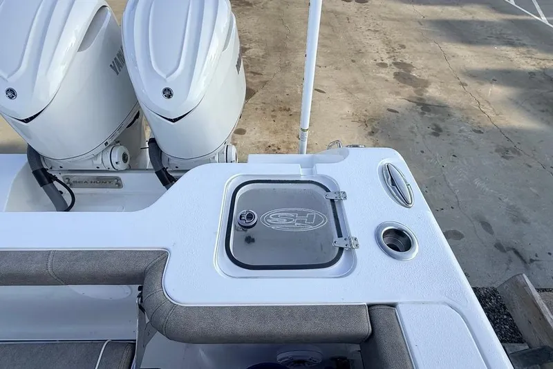 Slide: The Image of 2026 Sea Hunt Gamefish 30 Coffin Box boat with dual Yamaha engines, docked. - 24