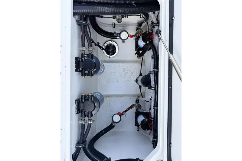Slide: The Image of Interior view of 2026 Sea Hunt Gamefish 30 Coffin Box, showcasing pumps and wiring. - 34