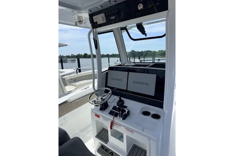 Slide: The Image of 2026 Sea Hunt Gamefish 30 Coffin Box boat dashboard with Garmin displays. - 7