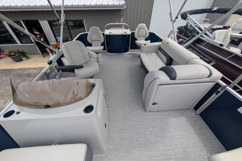 Slide: The Image of 2026 Starcraft EX 20 F pontoon boat interior with plush seating and modern helm. - 11